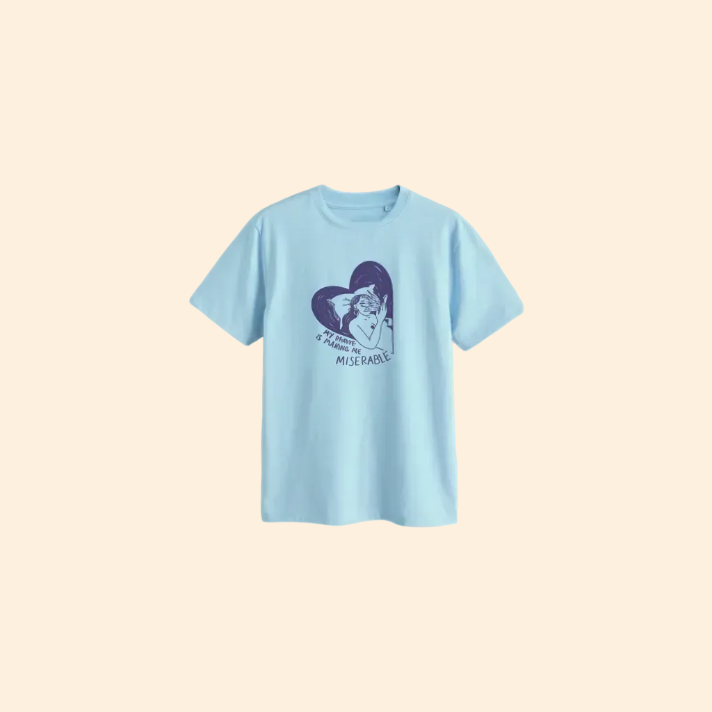 Light blue t-shirt with a graphic design on a beige background