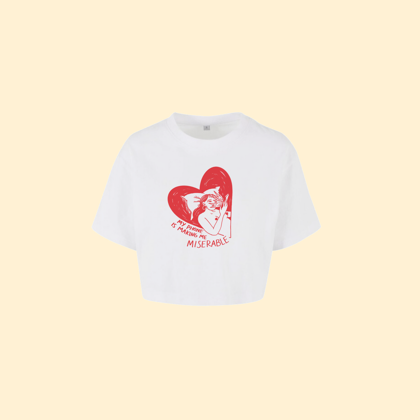White t-shirt crop top with red graphic and text on a beige background