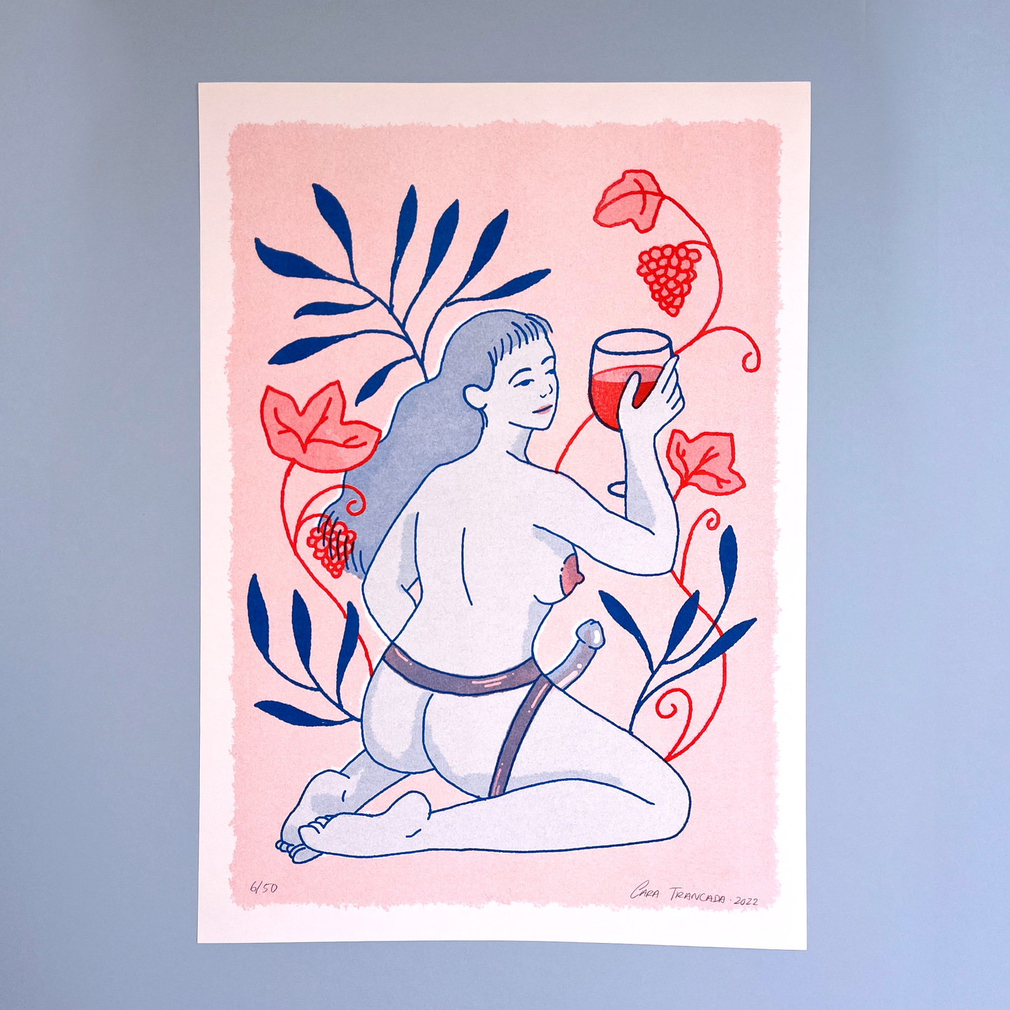 woman sensual with wine cup and grapes in pastel pink background